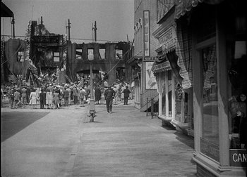 Movie still from “The Talk of the Town” (1942), directed by George Stevens – A black and white photo of a crowd of people walking down a street; Extreme Wide shot, High angle