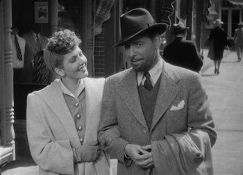 Movie still from “The Talk of the Town” (1942), directed by George Stevens – A man and a woman standing next to each other; Medium shot, High angle