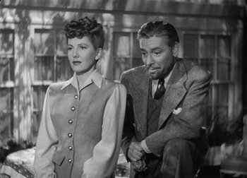 Movie still from “The Talk of the Town” (1942), directed by George Stevens – A man and a woman standing next to each other; Medium shot, Low angle