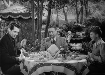 Movie still from “The Talk of the Town” (1942), directed by George Stevens – A man sitting at a table with a plate in front of him; Medium shot, High angle