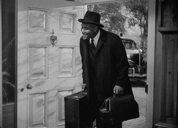 Movie still from “The Talk of the Town” (1942), directed by George Stevens – An older man in a hat and a suit carrying a suit case and briefcase; Medium shot, Low angle