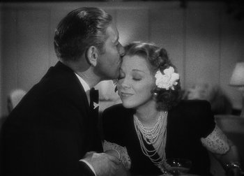 Movie still from “The Talk of the Town” (1942), directed by George Stevens – A man kissing a woman on the cheek at a party; Close Up shot, High angle