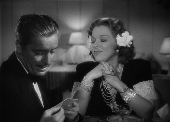Movie still from “The Talk of the Town” (1942), directed by George Stevens – A man and a woman sitting at a dinner table; Close Up shot, High angle