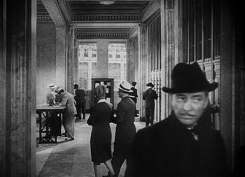 Movie still from “The Talk of the Town” (1942), directed by George Stevens – A group of people standing in a room; Medium shot, Low angle