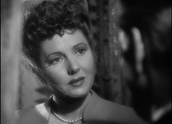 Movie still from “The Talk of the Town” (1942), directed by George Stevens – An old photo of an older woman with a pearl necklace; Close Up shot, Over the shoulder angle