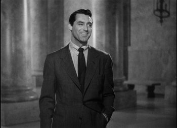 Movie still from “The Talk of the Town” (1942), directed by George Stevens – Black and white photograph of a man in a suit and tie; Medium shot, Low angle