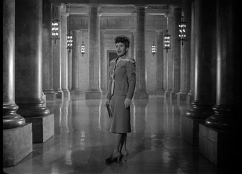 Movie still from “The Talk of the Town” (1942), directed by George Stevens – An old photo of a woman standing in an old building; Wide shot, Low angle