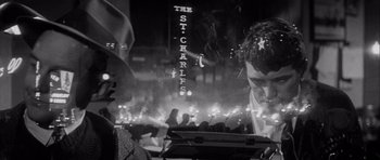 Movie still from “The Tarnished Angels” (1957), directed by Douglas Sirk – A black and white photo of a crowd of people at night; Close Up shot, Low angle