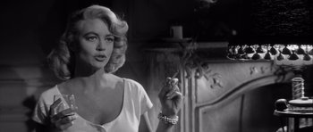 Movie still from “The Tarnished Angels” (1957), directed by Douglas Sirk – A black - and - white photo of a woman smoking a cigarette; Close Up shot, Over the shoulder angle