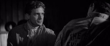 Movie still from “The Tarnished Angels” (1957), directed by Douglas Sirk – Black and white photograph of a man looking at the camera; Close Up shot, Over the shoulder angle