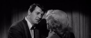 Movie still from “The Tarnished Angels” (1957), directed by Douglas Sirk – A man and a woman talking to each other; Close Up shot, Over the shoulder angle