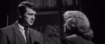 Movie still from “The Tarnished Angels” (1957), directed by Douglas Sirk – A man and a woman talking to each other; Close Up shot, Low angle