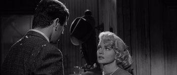 Movie still from “The Tarnished Angels” (1957), directed by Douglas Sirk – A man and a woman are looking at one another; Close Up shot, Over the shoulder angle