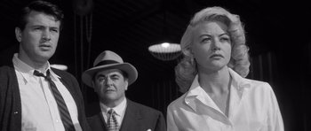 Movie still from “The Tarnished Angels” (1957), directed by Douglas Sirk – A black and white photo of a man and a woman; Medium shot, Low angle