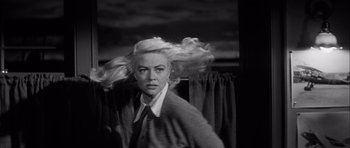 Movie still from “The Tarnished Angels” (1957), directed by Douglas Sirk – A black and white photo of a woman with long blonde hair; Close Up shot, Low angle