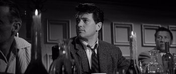 Movie still from “The Tarnished Angels” (1957), directed by Douglas Sirk – Black and white photograph of a man wearing a suit and tie; Close Up shot, Low angle
