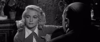 Movie still from “The Tarnished Angels” (1957), directed by Douglas Sirk – A woman is getting her hair combed by a man; Close Up shot, Over the shoulder angle