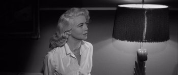 Movie still from “The Tarnished Angels” (1957), directed by Douglas Sirk – A black - and - white photo of a woman with blonde hair; Close Up shot, Low angle