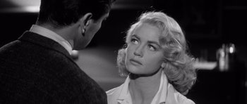 Movie still from “The Tarnished Angels” (1957), directed by Douglas Sirk – A man and a woman looking at one another; Close Up shot, Over the shoulder angle