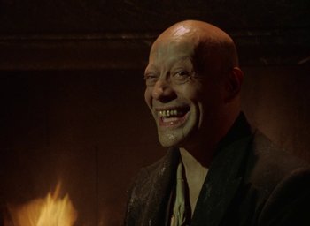 Movie still from “The Tempest” (1979), directed by Derek Jarman – A man with a bald head wearing a black jacket; Close Up shot, Low angle