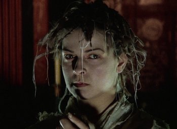 Movie still from “The Tempest” (1979), directed by Derek Jarman – A person wearing a wig; Close Up shot, Low angle