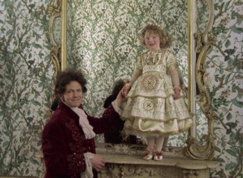 Movie still from “The Tempest” (1979), directed by Derek Jarman – A woman and a little girl are standing in front of a mirror; Medium shot, High angle