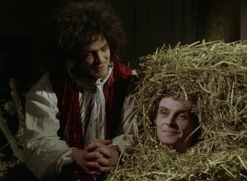 Movie still from “The Tempest” (1979), directed by Derek Jarman – A man and a woman in a straw hat; Medium shot, Over the shoulder angle