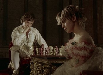 Movie still from “The Tempest” (1979), directed by Derek Jarman – A man and a woman are playing a game of chess; Medium shot, Over the shoulder angle
