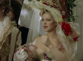 Movie still from “The Tempest” (1979), directed by Derek Jarman – A woman in a bridal gown holding a spoon; Medium shot, Low angle