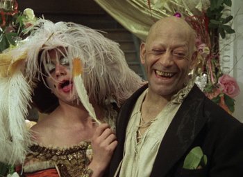 Movie still from “The Tempest” (1979), directed by Derek Jarman – A man and a woman dressed up in costumes; Close Up shot, Low angle