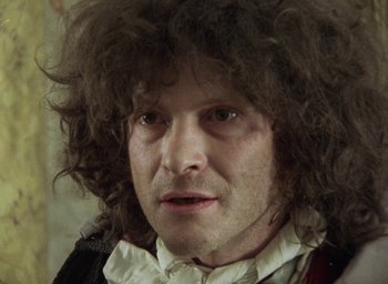 Movie still from “The Tempest” (1979), directed by Derek Jarman – A person wearing a wig; Close Up shot, Low angle