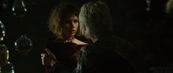 Movie still from “The Tempest” (2010), directed by Julie Taymor – A woman in a red dress talking to another woman in a black dress; Close Up shot, Over the shoulder angle