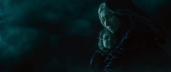 Movie still from “The Tempest” (2010), directed by Julie Taymor – A woman and a child are standing in the dark; Close Up shot, Low angle