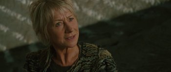 Movie still from “The Tempest” (2010), directed by Julie Taymor – An older woman with blonde hair wearing a green jacket; Close Up shot, Over the shoulder angle