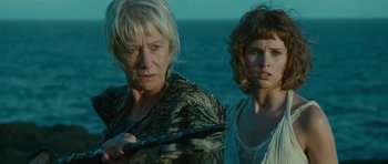 Movie still from “The Tempest” (2010), directed by Julie Taymor – Two women standing next to each other in front of a body of water; Close Up shot, Low angle