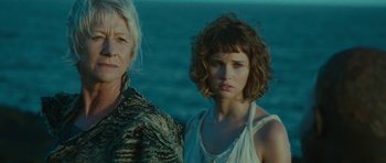 Movie still from “The Tempest” (2010), directed by Julie Taymor – Two women standing next to each other near a body of water; Close Up shot, Low angle