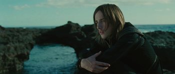 Movie still from “The Tempest” (2010), directed by Julie Taymor – A young woman standing in front of a body of water; Close Up shot, High angle
