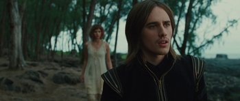 Movie still from “The Tempest” (2010), directed by Julie Taymor – A man and a woman walking through a forest; Close Up shot, Over the shoulder angle