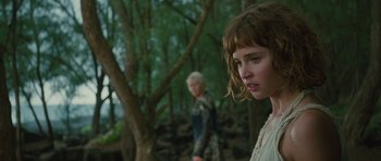 Movie still from “The Tempest” (2010), directed by Julie Taymor – Two people in the woods with trees in the background; Close Up shot, Over the shoulder angle