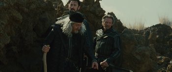 Movie still from “The Tempest” (2010), directed by Julie Taymor – A group of men standing next to each other; Medium shot, Low angle