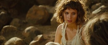 Movie still from “The Tempest” (2010), directed by Julie Taymor – A beautiful woman sitting on top of a rock; Close Up shot, Over the shoulder angle