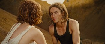 Movie still from “The Tempest” (2010), directed by Julie Taymor – A man with long brown hair looking into a mirror; Close Up shot, Over the shoulder angle