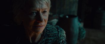 Movie still from “The Tempest” (2010), directed by Julie Taymor – An older woman is looking at the camera; Close Up shot, Low angle