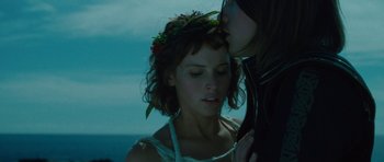 Movie still from “The Tempest” (2010), directed by Julie Taymor – A young woman with a wreath on her head is kissing a young man; Close Up shot, Overhead angle