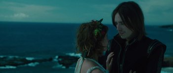 Movie still from “The Tempest” (2010), directed by Julie Taymor – Two people standing next to each other near the ocean; Medium shot, Over the shoulder angle