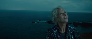 Movie still from “The Tempest” (2010), directed by Julie Taymor – A woman standing in front of a body of water at night; Close Up shot, Low angle