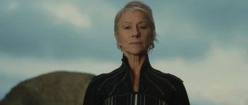 Movie still from “The Tempest” (2010), directed by Julie Taymor – An older woman wearing a black jacket looking into the distance; Close Up shot, Low angle