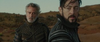 Movie still from “The Tempest” (2010), directed by Julie Taymor – Two men standing next to each other on top of a hill; Close Up shot, Over the shoulder angle