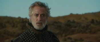 Movie still from “The Tempest” (2010), directed by Julie Taymor – A person with a beard; Close Up shot, Over the shoulder angle