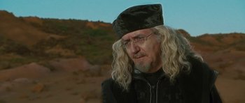 Movie still from “The Tempest” (2010), directed by Julie Taymor – An older man with long hair and a hat; Close Up shot, Over the shoulder angle